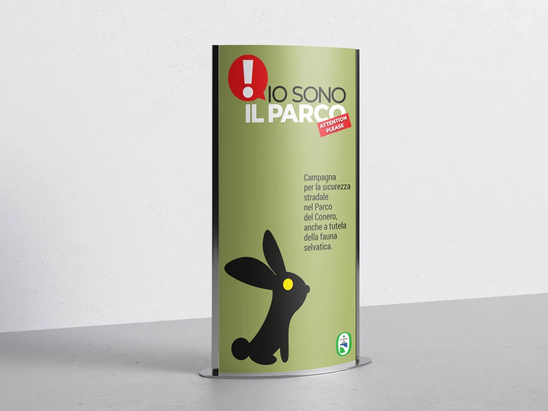 Totem curvo su fondo chiaro, stampato verde oliva, con il titolo in alto, il testo della campagna e la sagoma di una lepre dall'occhio giallo che occupa la parte bassa.
